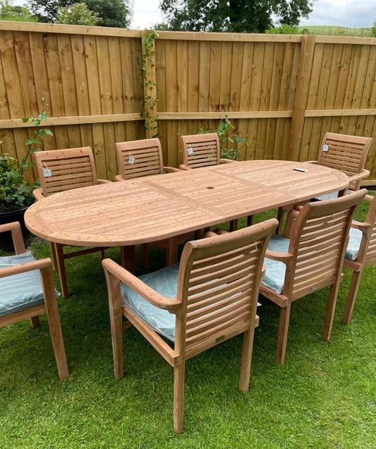Ascot teak dining set with 8 stacking chairs and green seat cushions