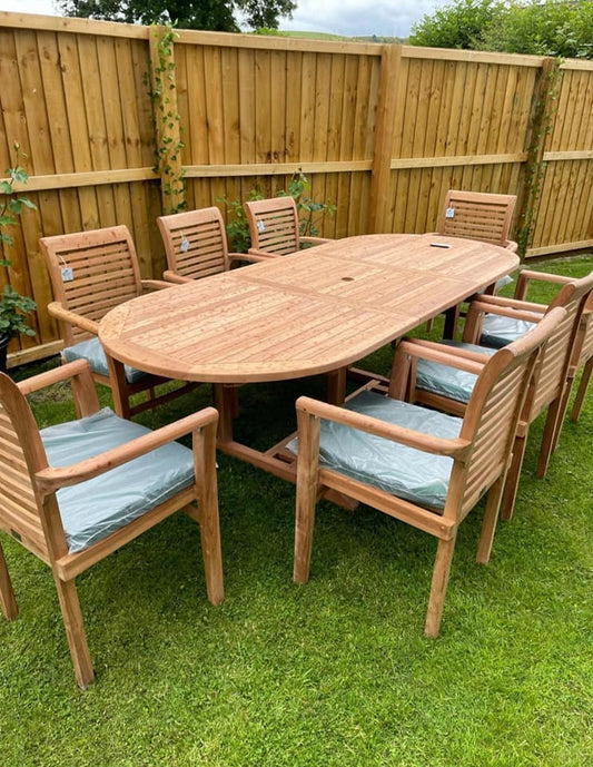 Ascot 8 seater teak dining set with oval single leaf extending table on a lawn