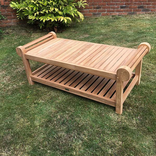 Lutyens double tier teak garden coffee table, 130cm, on grass